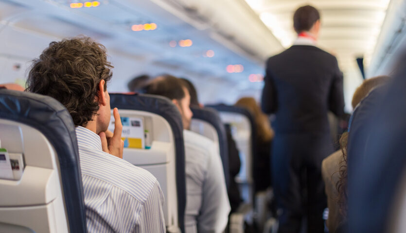 Matej Kastelic / Shutterstock man thinking sitting in an aisle seat on an airplane