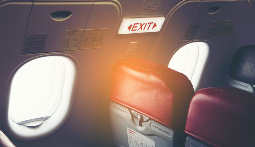FOTOAMP / Shutterstock exit row seats on an airplane