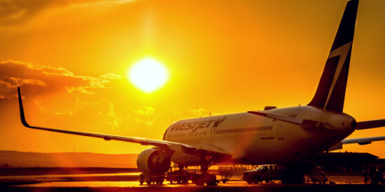 WestJet Boeing 767 on tarmac in Calgary, Canada during sunset