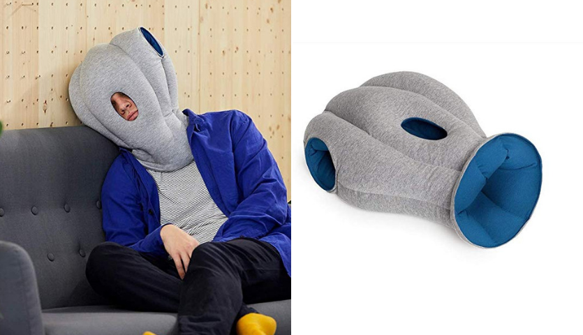 Man in Ostrich Pillow leans against wall to sleep