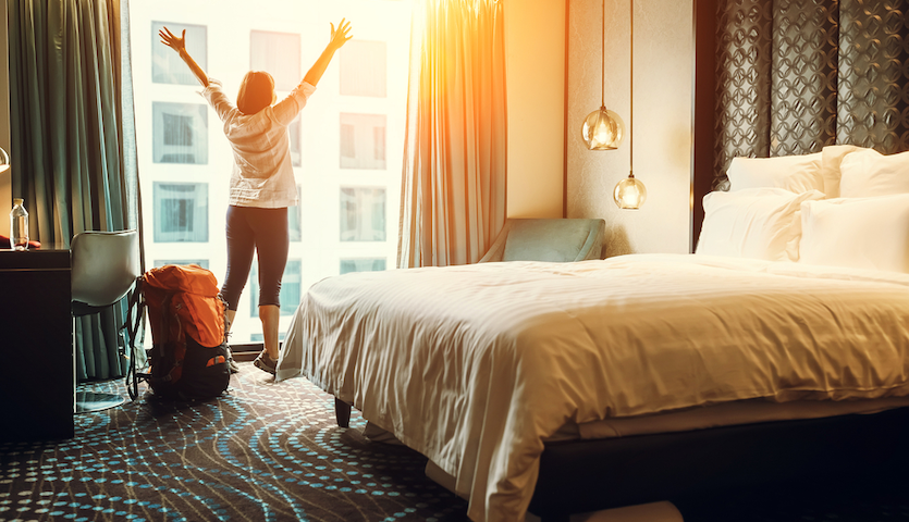 Woman excited about staying in a hotel