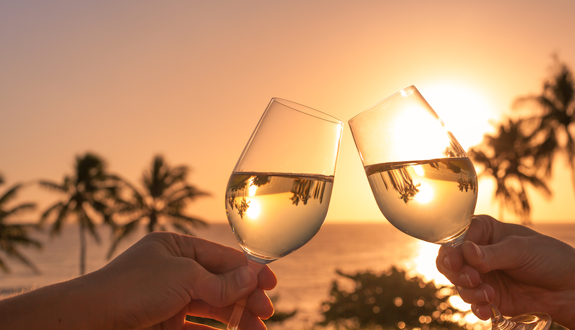 Drinking wine at sunset and clinking glasses
