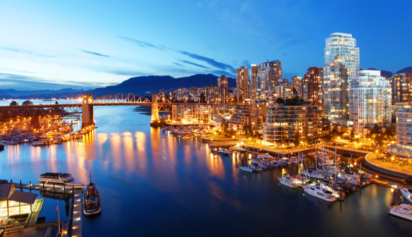 vancouver at night, lights reflecting into water, mountain in background