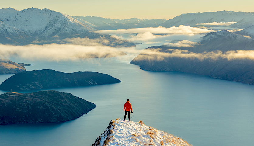 Man looking out over lake Wanaka near Queenstown New Zealand