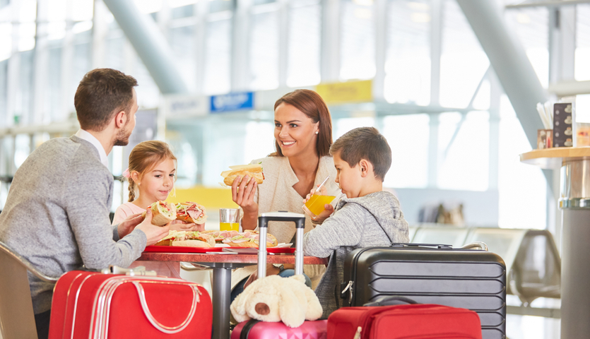 Family eating food at airport