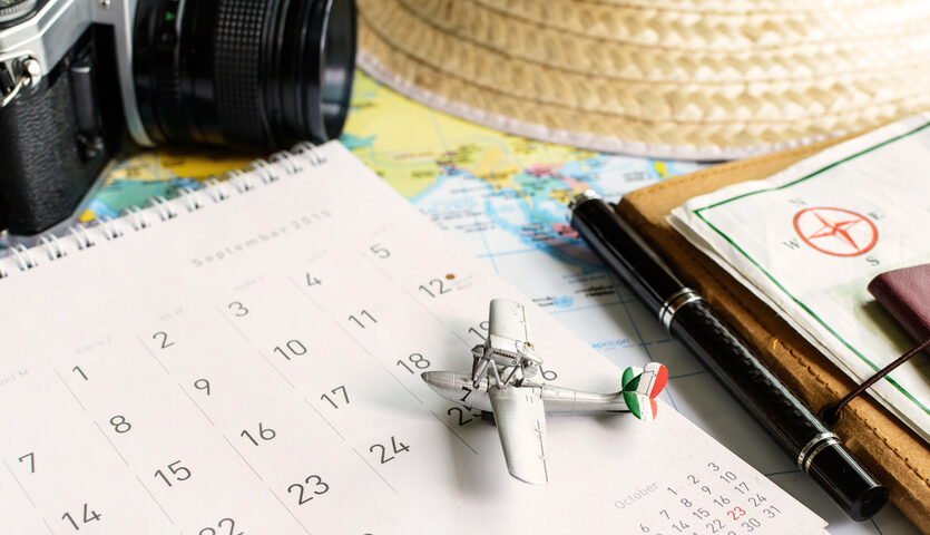 model airplane on top of a calendar during travel planning