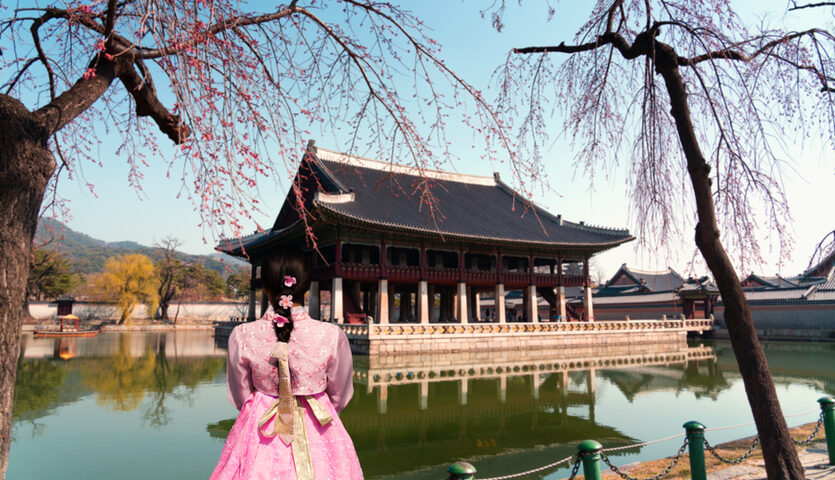 young woman looking at gyeongbokgune palace in seoul south korea